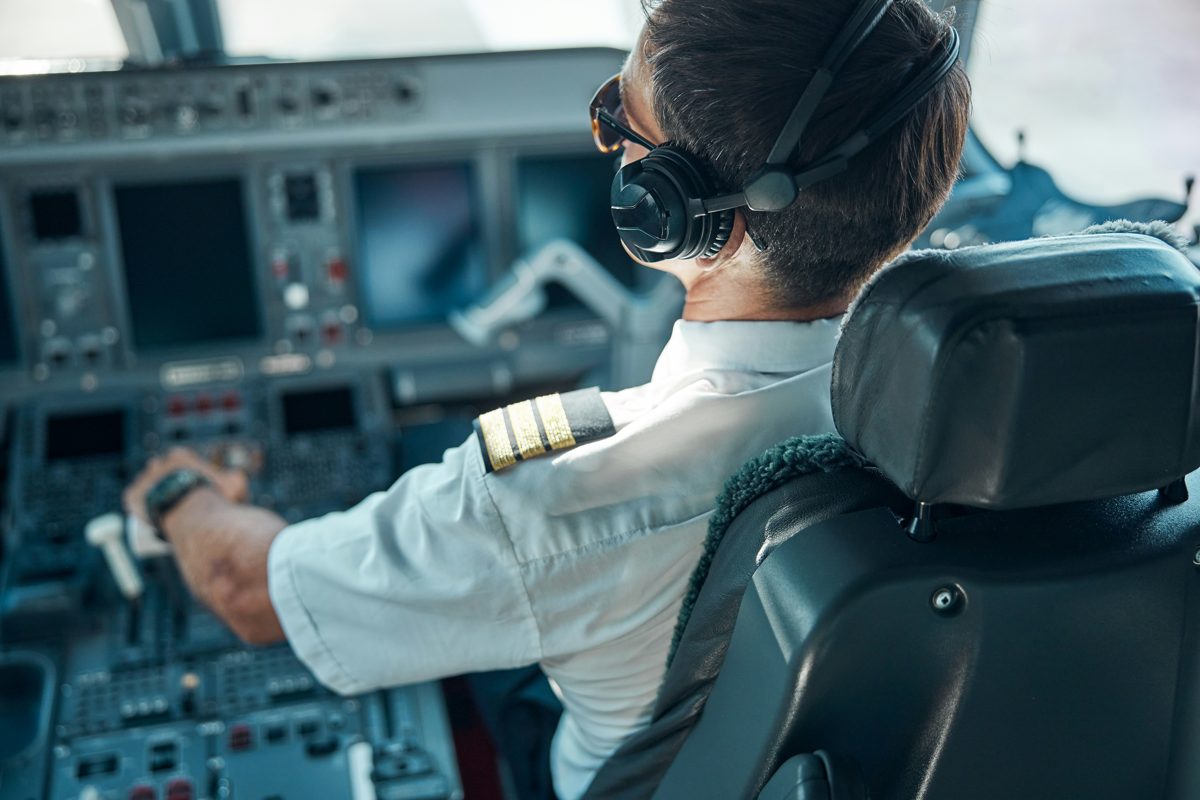 Pilot at the controls of a modern flight deck